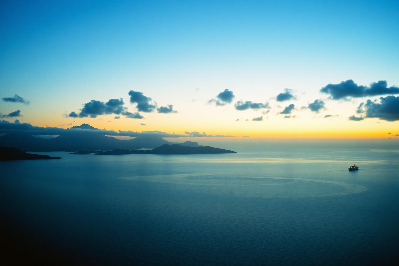 Distant ship on the horizon beyond a Caribbean bay